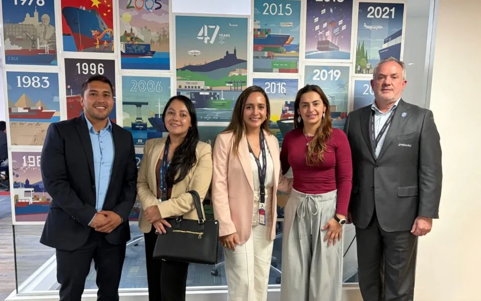 The OnBoard team in front of a wall of CMA CGM history posters