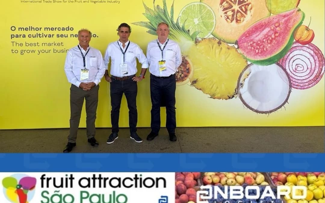 Three OnBoard team members in front of the fruit wall at Fruit Attraction São Paulo