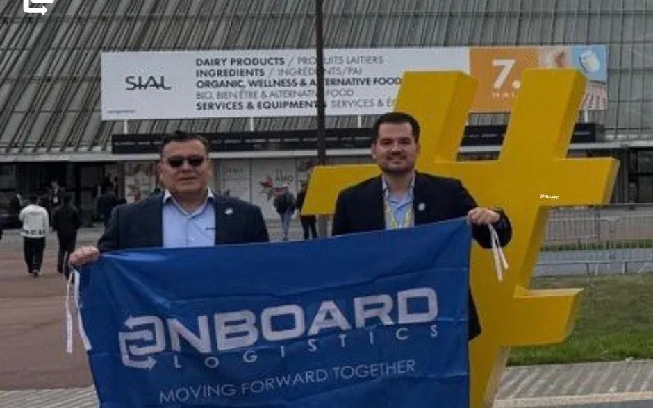 The OnBoard Paraguay representatives with the OnBoard Logistics flag in front of a SIAL Paris 2026 hall